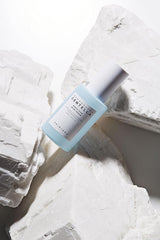 Lightweight blue serum texture applied on skin close up