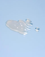 Lightweight blue serum texture applied on skin close up